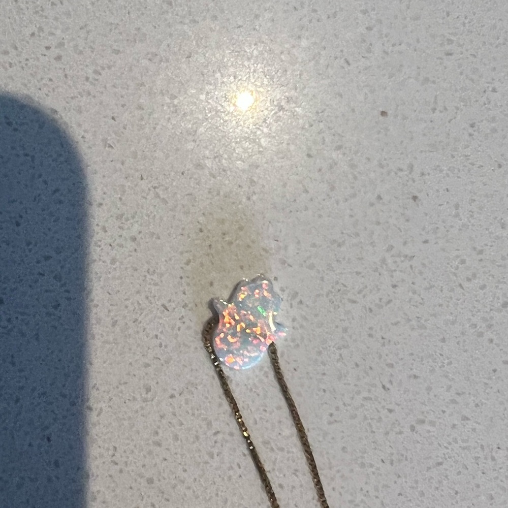 Gold chain and white hamsa necklace